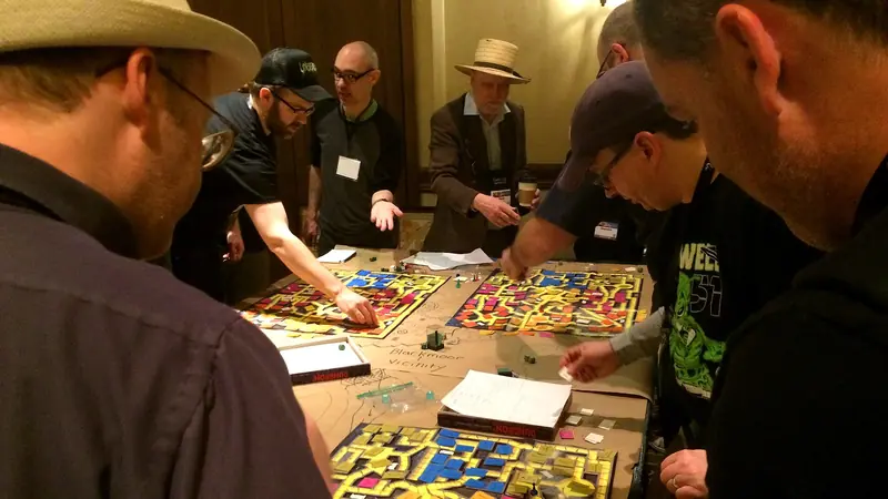Players around a dungeon board at Gary Con 2018